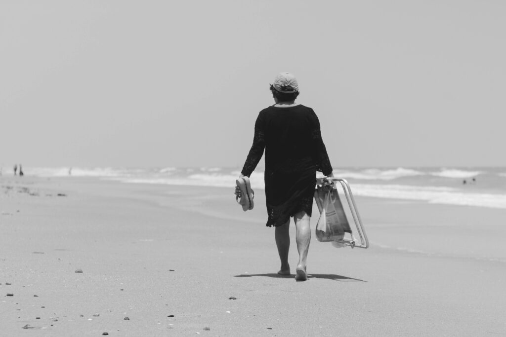 A lone figure walks along Aracati beach, capturing the tranquil essence of a Brazilian coastal escape.
